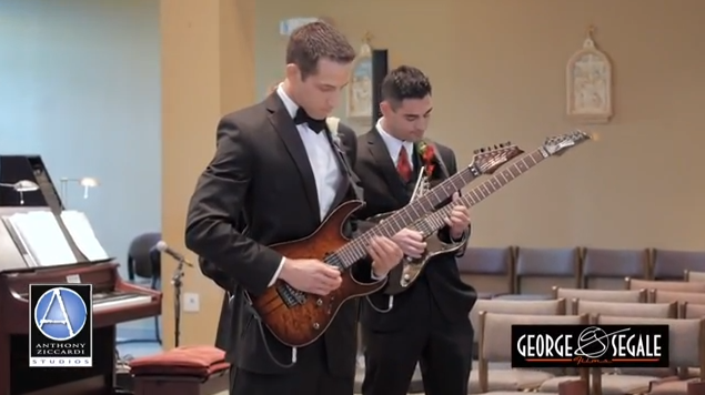 Groom and groomsmen playing guitar during wedding entrance.