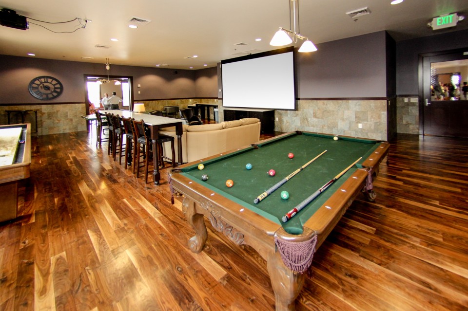 Groom room with bar, projector screen and pool tables.