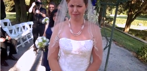 View of bride, during the ceremony, from pov of groom hidden camera.