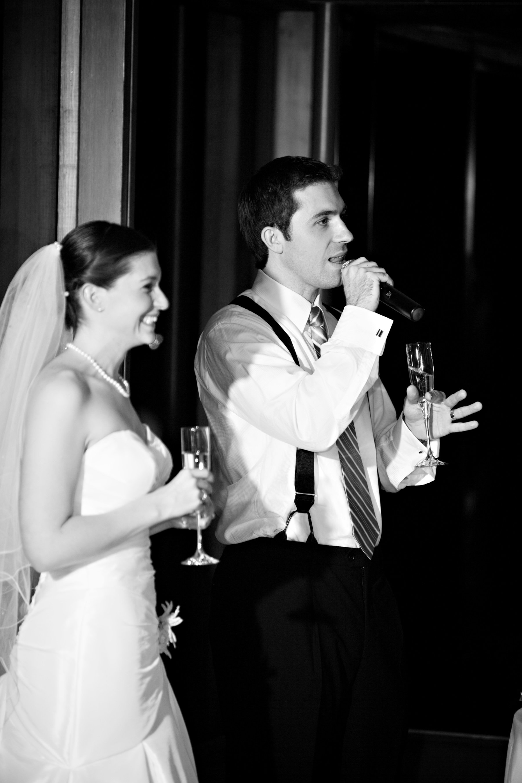 Groom giving wedding speech standing next to his bride.