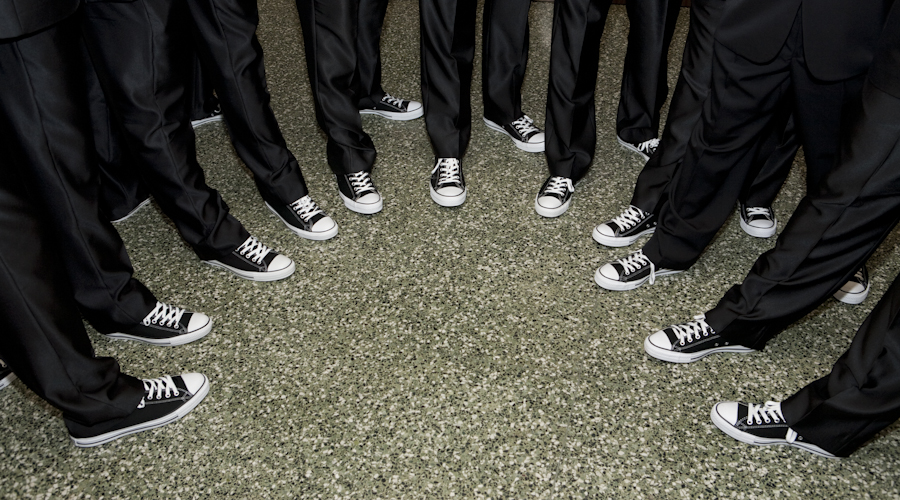 Groom and groomsmen wearing Converse Chuck Taylors shoes.