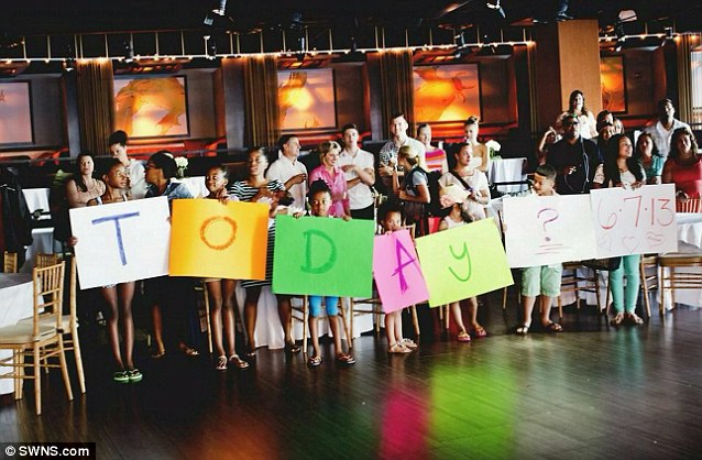 Family and friends of Ryan and Amanda hold sign 