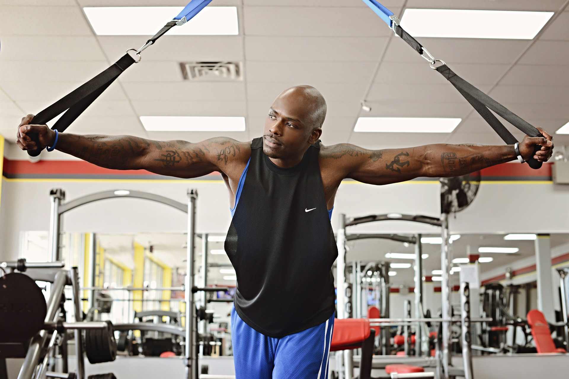 Black man working out in a gym.