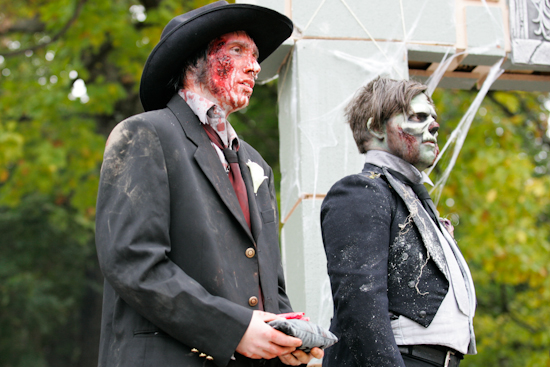 Zombie groom and best man during wedding ceremony.